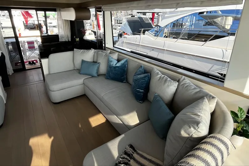 Yacht Photos Pics Luxurious interior of 2024 Azimut Magellano 60 yacht with elegant seating and large windows.