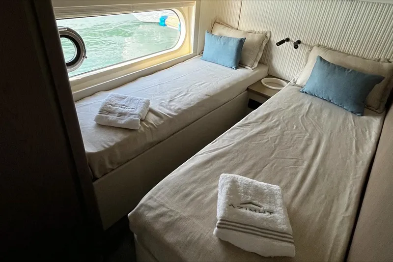  Yacht Photos Pics Luxurious twin cabin interior of 2024 Azimut Magellano 60 yacht with elegant bedding.