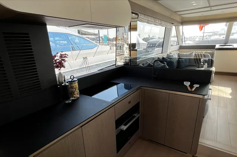  Yacht Photos Pics Luxurious interior of 2024 Azimut Magellano 60 yacht with modern kitchen and seating area.