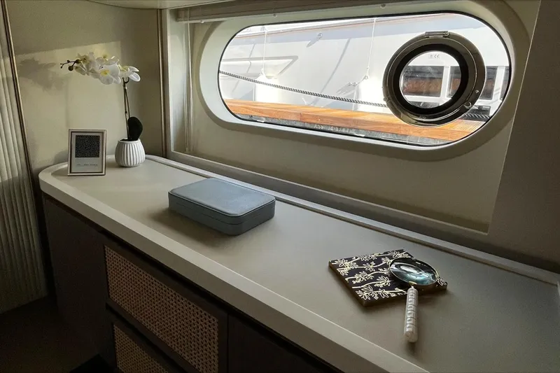  Yacht Photos Pics Luxurious interior of 2024 Azimut Magellano 60 yacht with elegant decor and porthole view.