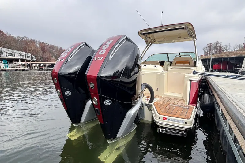  Yacht Photos Pics 2026 Chris-Craft Calypso 28 with dual 300 V8 engines docked on a calm lake.