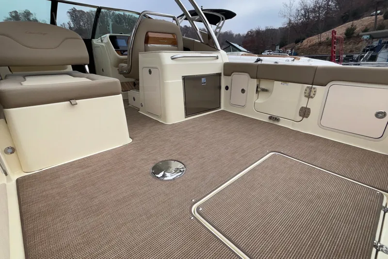  Yacht Photos Pics 2026 Chris-Craft Calypso 28 boat interior with beige seating and carpeted flooring.