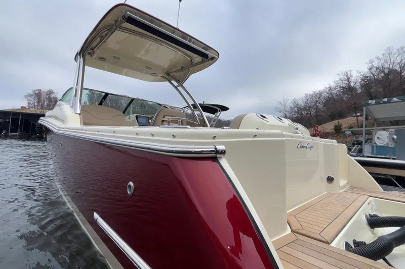  Yacht Photos Pics 2026 Chris-Craft Calypso 28 boat with red and cream exterior on the water.