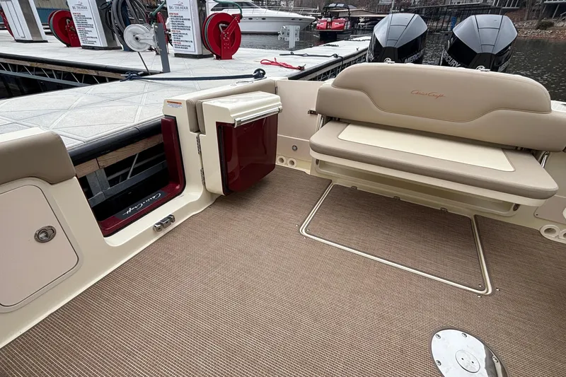  Yacht Photos Pics 2026 Chris-Craft Calypso 28 boat interior with beige seating and dock view.