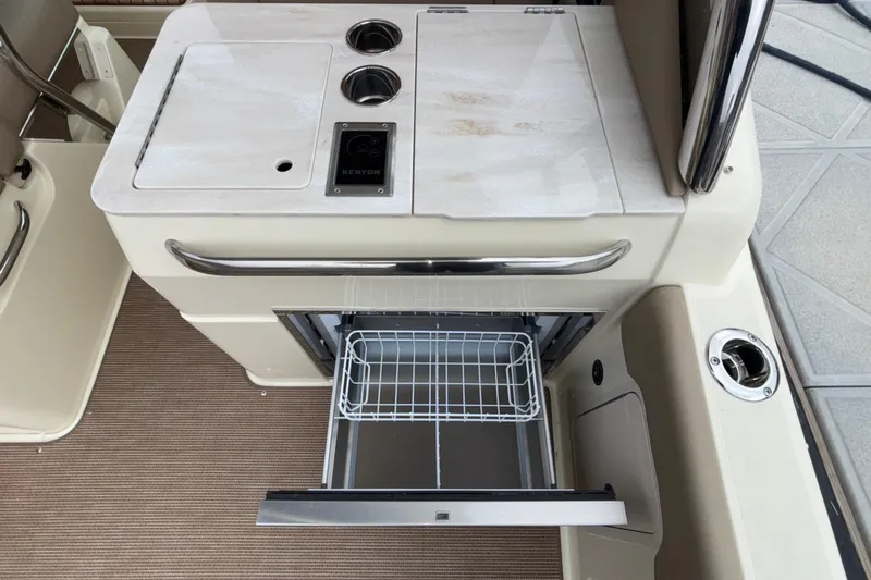  Yacht Photos Pics 2026 Chris-Craft Calypso 28 boat interior with open drawer and Kenyon cooktop.