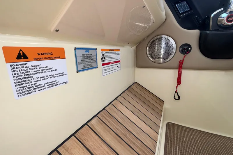  Yacht Photos Pics 2026 Chris-Craft Calypso 28 interior with safety warnings and speaker detail.