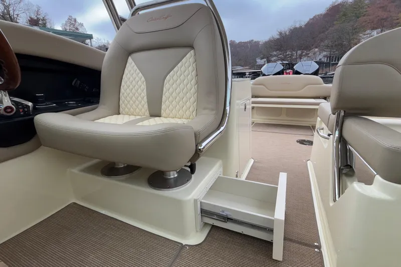  Yacht Photos Pics 2026 Chris-Craft Calypso 28 interior with beige seating and storage drawer.
