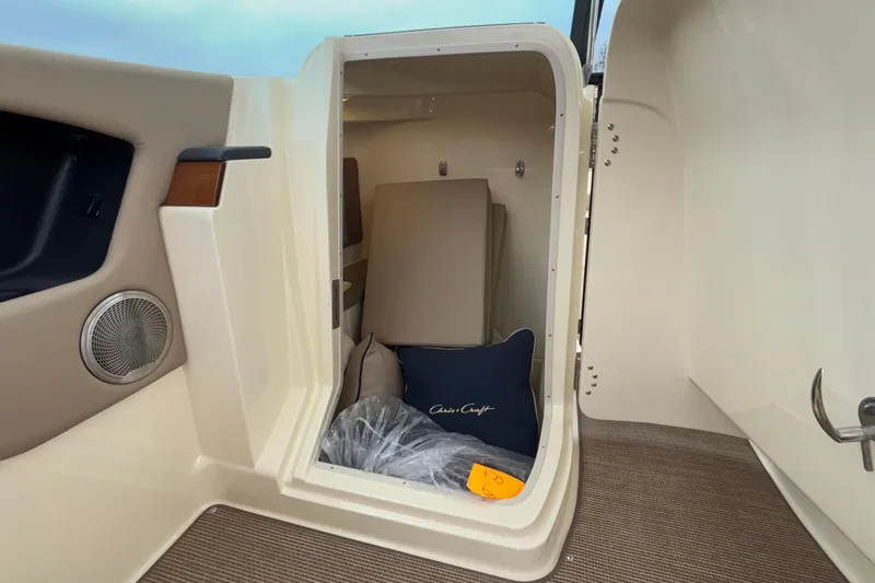  Yacht Photos Pics 2026 Chris-Craft Calypso 28 cabin interior with cushions and speaker.