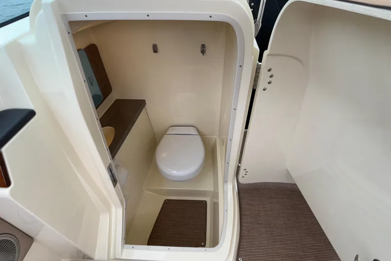  Yacht Photos Pics 2026 Chris-Craft Calypso 28 boat interior bathroom with toilet and compact design.