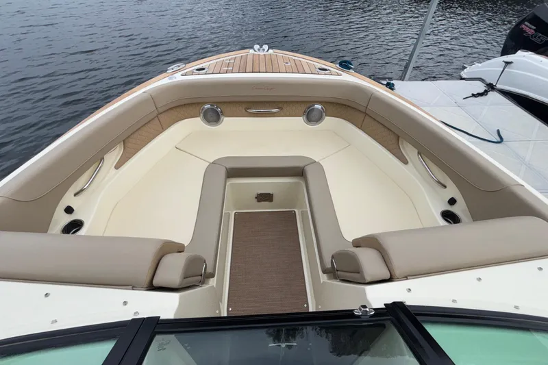  Yacht Photos Pics Luxurious 2026 Chris-Craft Calypso 28 boat interior with elegant seating and teak accents.