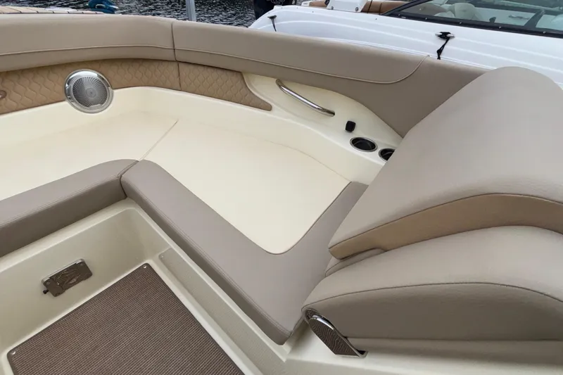  Yacht Photos Pics Luxurious interior of 2026 Chris-Craft Calypso 28 boat with beige seating and speaker.
