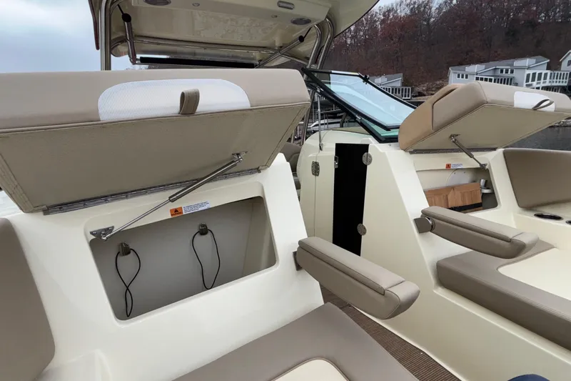  Yacht Photos Pics 2026 Chris-Craft Calypso 28 boat interior with open storage compartments and seating.