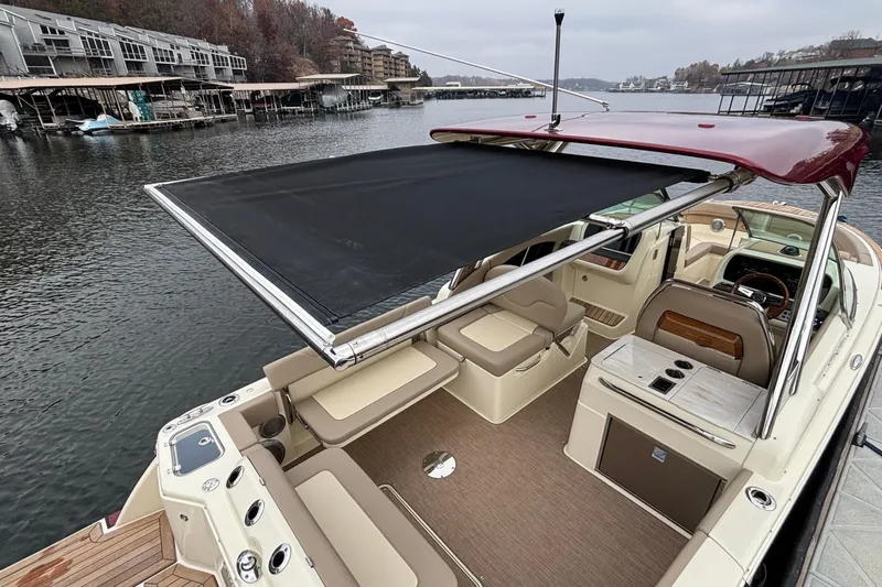  Yacht Photos Pics 2026 Chris-Craft Calypso 28 boat with retractable sunshade on a calm lake.