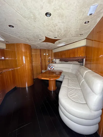  Yacht Photos Pics Luxurious interior of 2002 Sunseeker Predator 61 yacht with elegant wood paneling and plush seating.