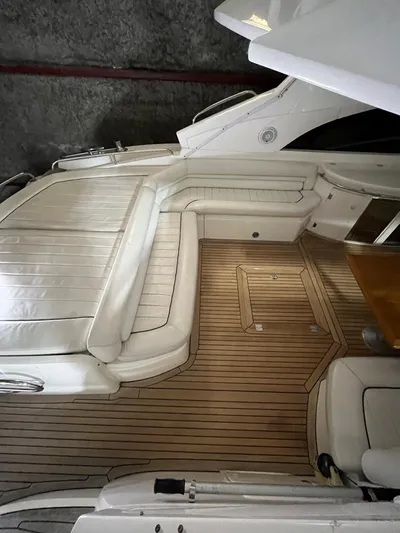  Yacht Photos Pics Interior of 2002 Sunseeker Predator 61 yacht with white seating and wooden flooring.
