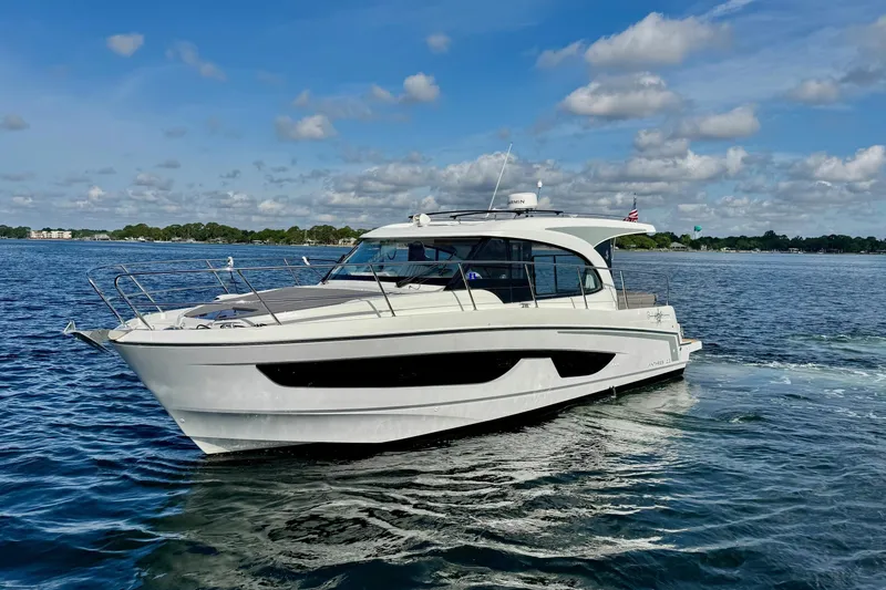 Venture Yacht Photos Pics 2024 Beneteau Antares 11 yacht cruising on a sunny day with blue skies.