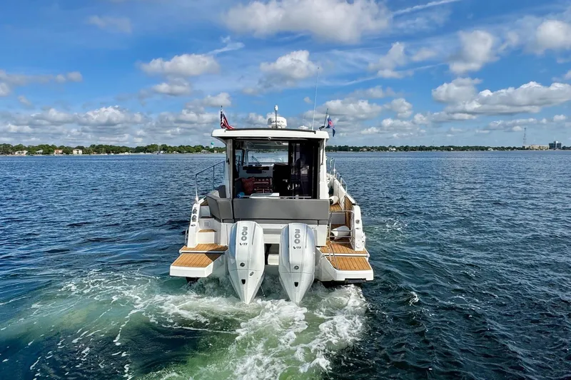 Venture Yacht Photos Pics 2024 Beneteau Antares 11 cruising on a sunny day with twin outboard engines.