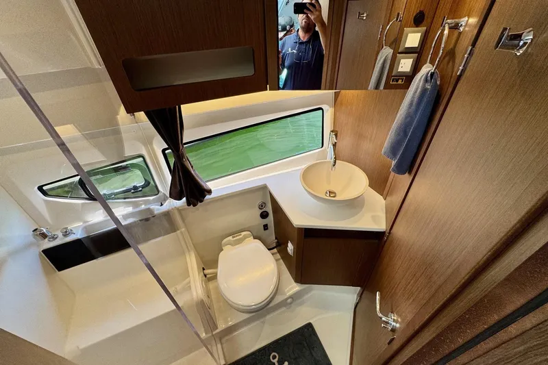 Venture Yacht Photos Pics 2024 Beneteau Antares 11 bathroom with modern fixtures and wood accents.