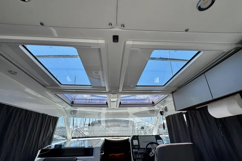 Venture Yacht Photos Pics Interior view of 2024 Beneteau Antares 11 with skylights and modern helm.