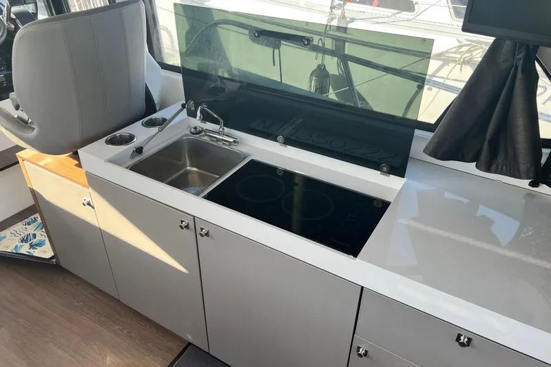 Venture Yacht Photos Pics 2024 Beneteau Antares 11 interior kitchen with sink and stove.