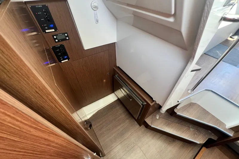 Venture Yacht Photos Pics 2024 Beneteau Antares 11 interior with wood paneling and control panels.