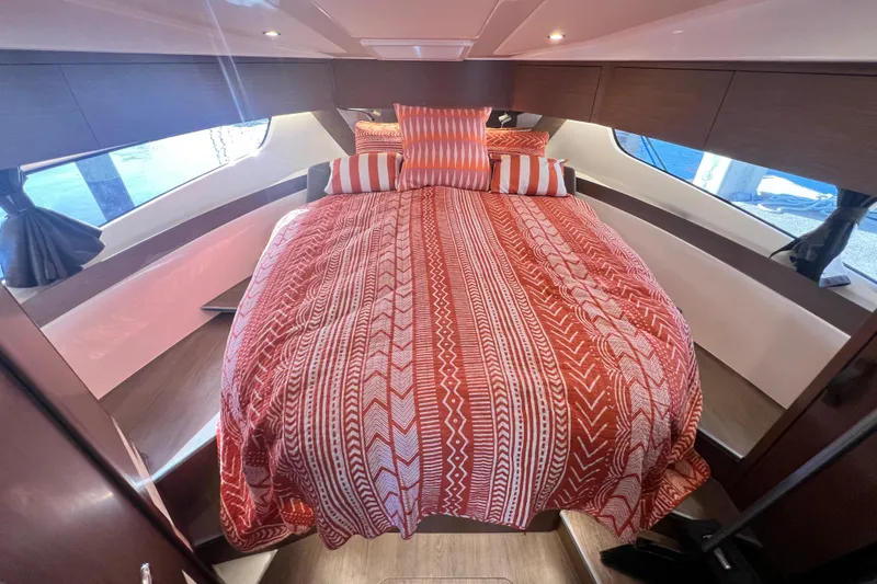 Venture Yacht Photos Pics Luxurious cabin interior of 2024 Beneteau Antares 11 with patterned bedding.