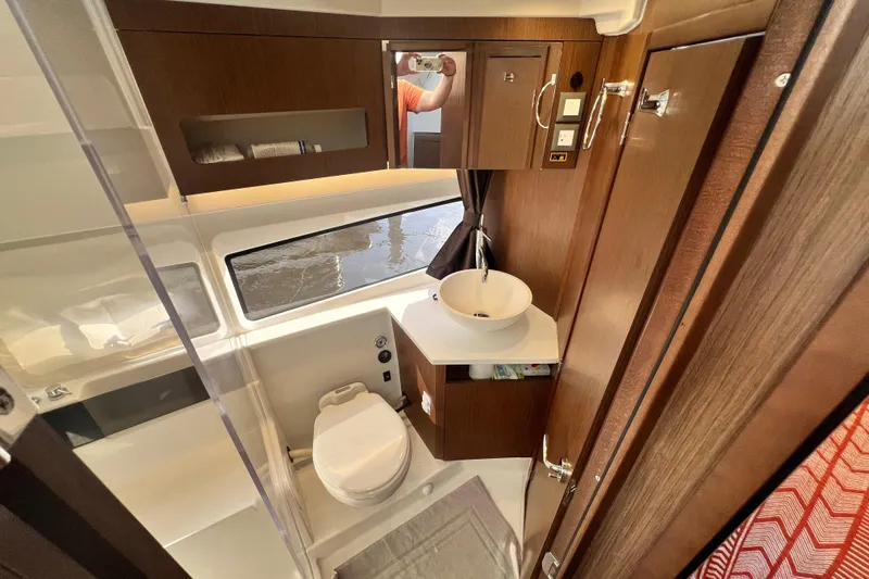 Venture Yacht Photos Pics 2024 Beneteau Antares 11 bathroom with modern fixtures and wood cabinetry.