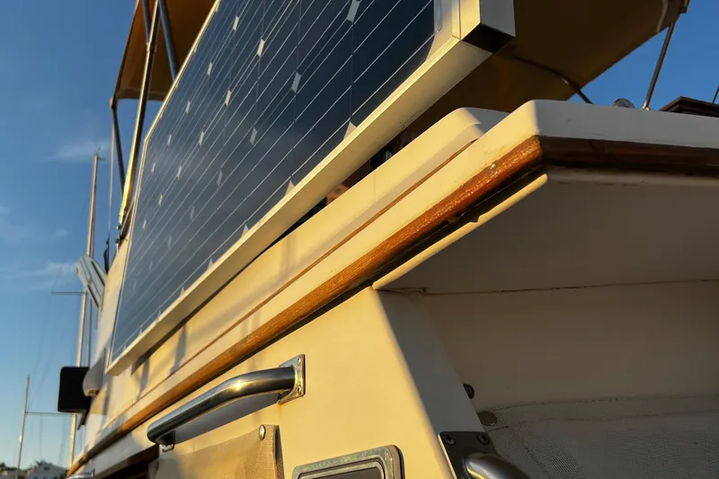 Apta Yacht Photos Pics 1989 Grand Banks 36 Classic boat with solar panels, close-up view in sunlight.