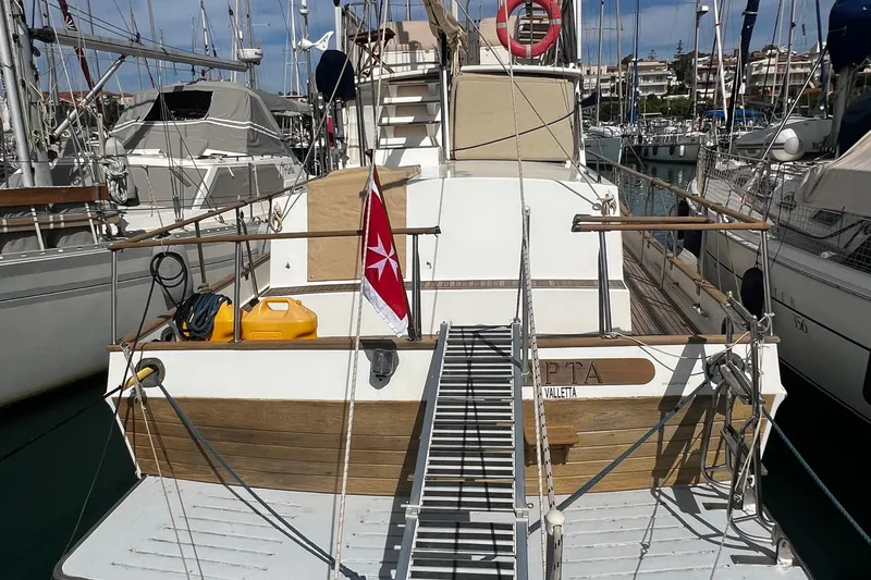 Apta Yacht Photos Pics 1989 Grand Banks 36 Classic yacht docked at marina, featuring wooden deck and nautical equipment.