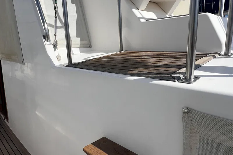 Apta Yacht Photos Pics 1989 Grand Banks 36 Classic yacht deck with wooden flooring and metal railings.