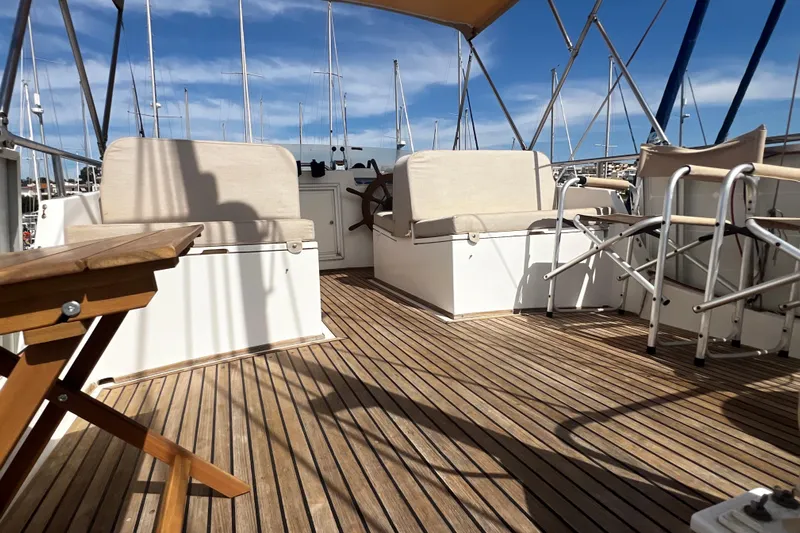 Apta Yacht Photos Pics 1989 Grand Banks 36 Classic yacht deck with seating and wooden flooring.