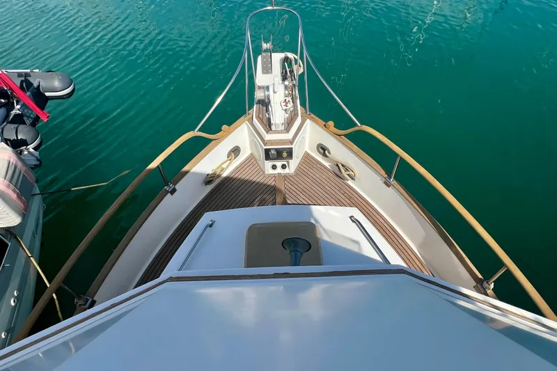 Apta Yacht Photos Pics Bow view of 1989 Grand Banks 36 Classic yacht on calm water.