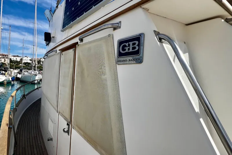 Apta Yacht Photos Pics 1989 Grand Banks 36 Classic yacht docked in a marina, showcasing its elegant design.