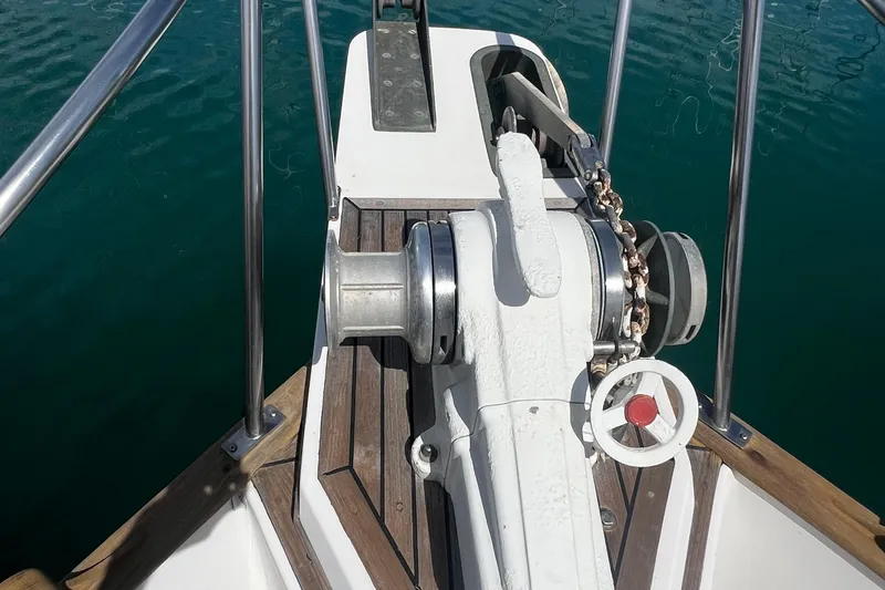 Apta Yacht Photos Pics Anchor windlass on 1989 Grand Banks 36 Classic yacht, docked on calm water.