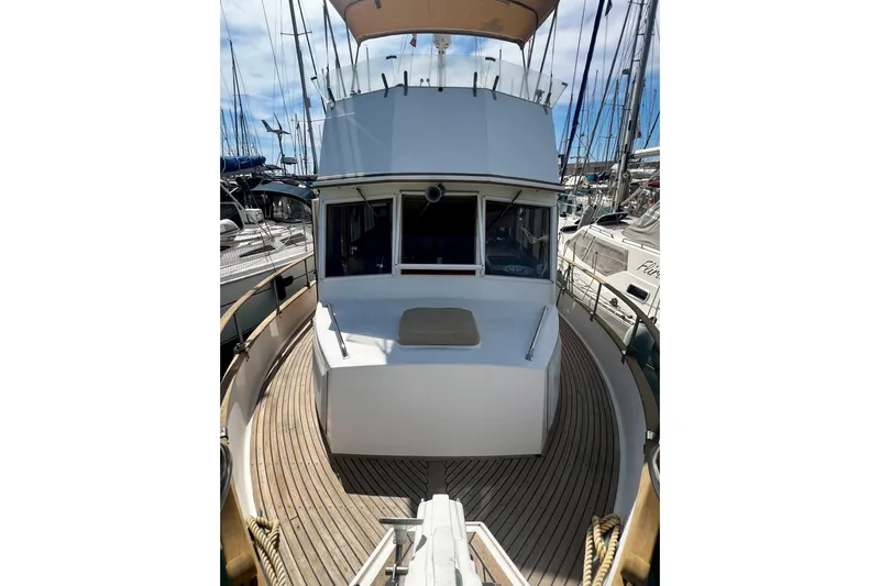 Apta Yacht Photos Pics 1989 Grand Banks 36 Classic yacht with wooden deck, docked at marina.