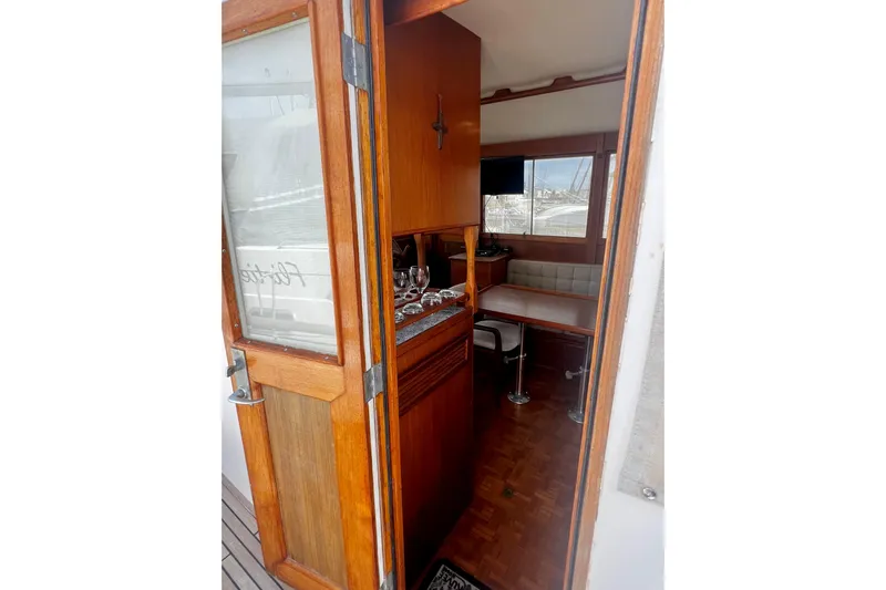 Apta Yacht Photos Pics 1989 Grand Banks 36 Classic yacht interior with wooden door and cozy seating area.