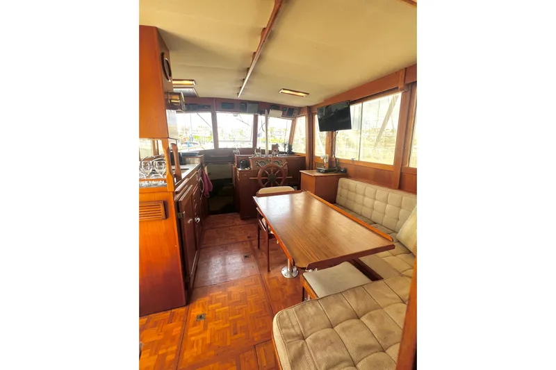 Apta Yacht Photos Pics Interior of 1989 Grand Banks 36 Classic yacht with wooden furnishings and seating area.