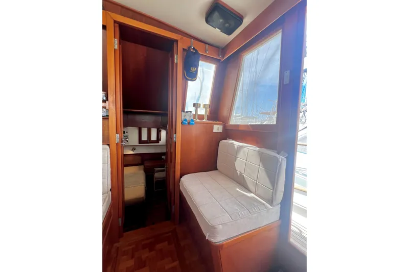 Apta Yacht Photos Pics 1989 Grand Banks 36 Classic interior with wooden finish and cushioned seating.