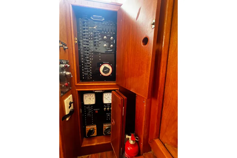 Apta Yacht Photos Pics Electrical panel inside 1989 Grand Banks 36 Classic boat with wooden cabinetry and fire extinguisher.