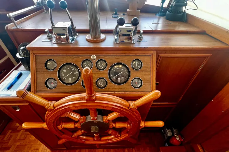 Apta Yacht Photos Pics Wooden helm of 1989 Grand Banks 36 Classic with gauges and controls.