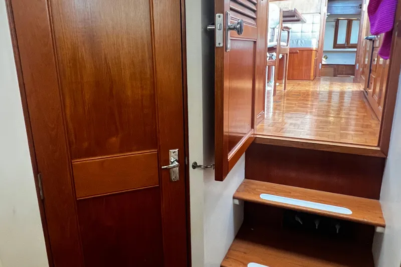 Apta Yacht Photos Pics Interior of 1989 Grand Banks 36 Classic yacht with wooden stairs and door.