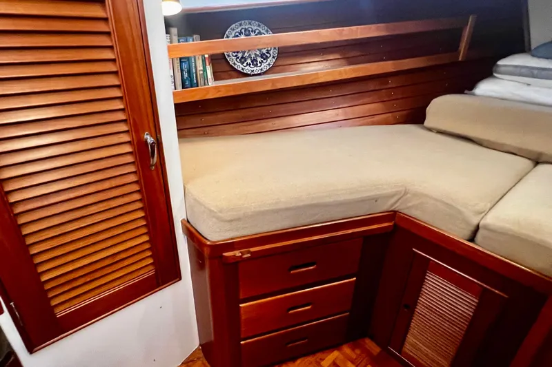 Apta Yacht Photos Pics Cozy cabin interior of 1989 Grand Banks 36 Classic with wooden furnishings and built-in storage.