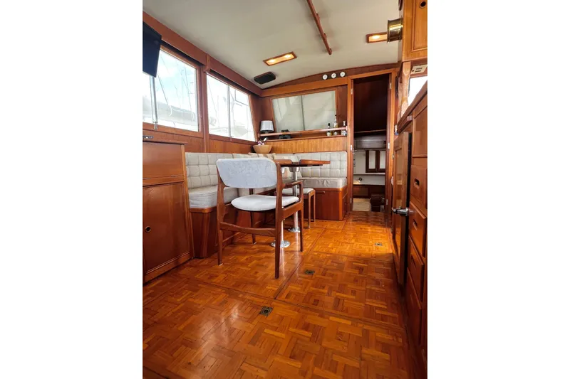 Apta Yacht Photos Pics Interior of 1989 Grand Banks 36 Classic yacht with wooden furnishings and seating area.