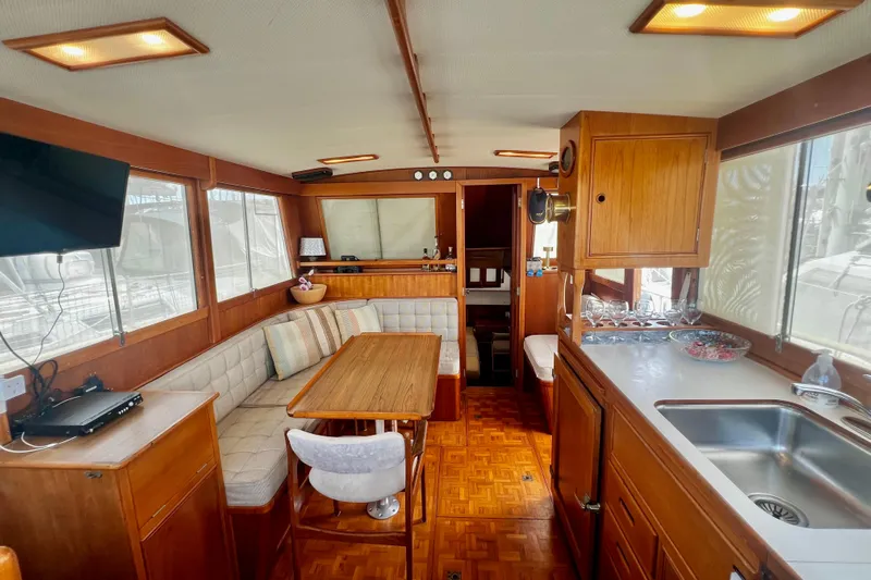 Apta Yacht Photos Pics Interior of 1989 Grand Banks 36 Classic yacht with wood finish and cozy seating area.