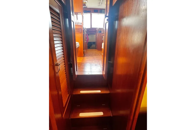 Apta Yacht Photos Pics Interior view of 1989 Grand Banks 36 Classic yacht, featuring wooden stairs and cabin.