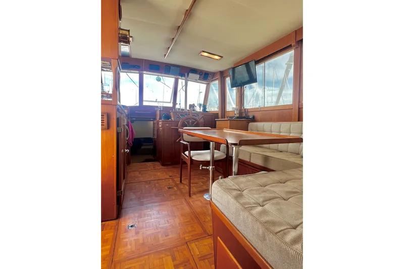 Apta Yacht Photos Pics Interior of 1989 Grand Banks 36 Classic yacht with wood finish and seating area.