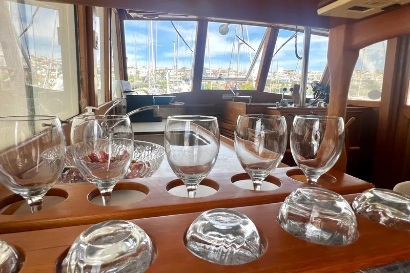 Apta Yacht Photos Pics Interior of 1989 Grand Banks 36 Classic yacht with glassware and marina view.