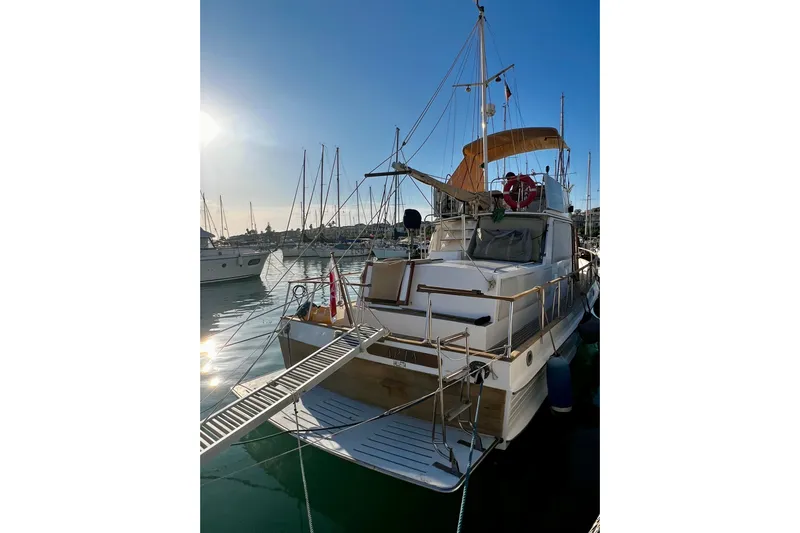 Apta Yacht Photos Pics 1989 Grand Banks 36 Classic yacht docked in a marina at sunset.