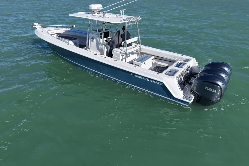  Yacht Photos Pics 2007 Contender 33 Tournament boat with triple Yamaha engines on open water.