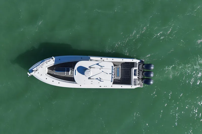  Yacht Photos Pics Aerial view of 2007 Contender 33 Tournament boat on green water.